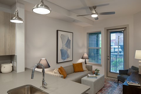 a living room with a couch and a coffee table in front of a window