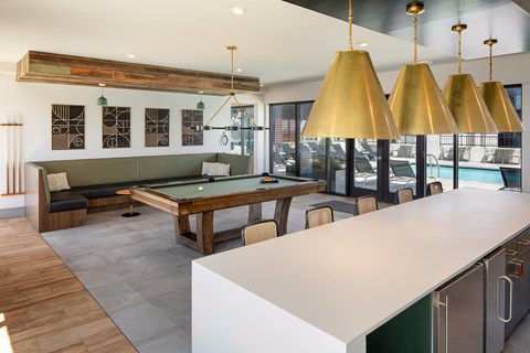 a pool table in the clubhouse at ascend at woodbury apartments in wilmington, nc