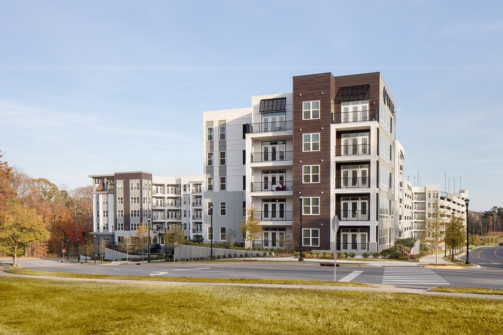 a rendering of a new apartment building on a city street