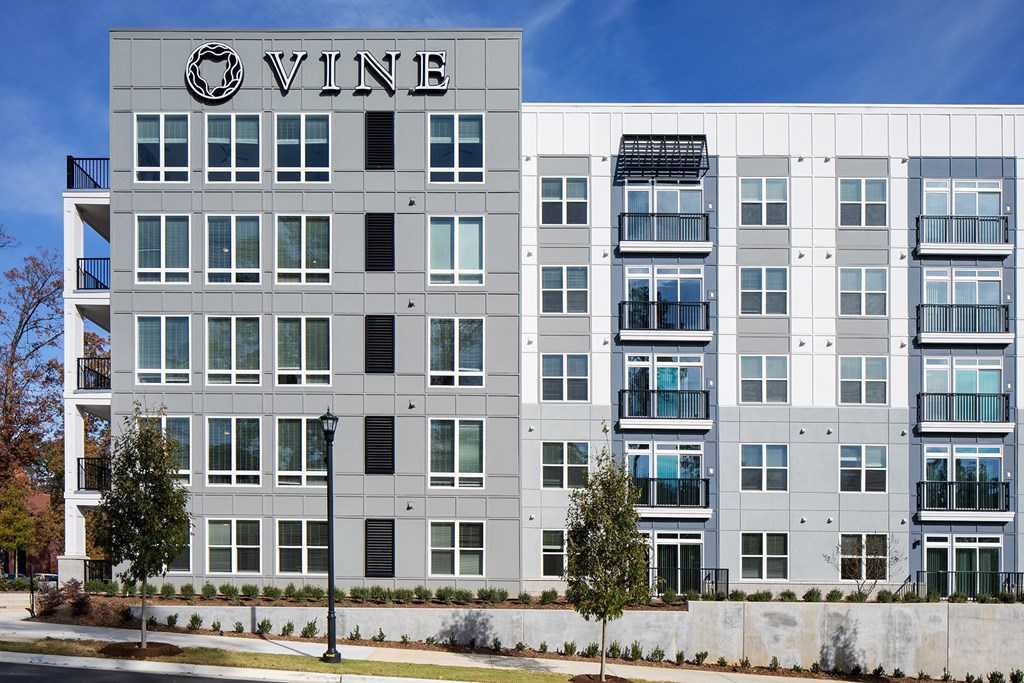 a white building with a vine logo on top of it