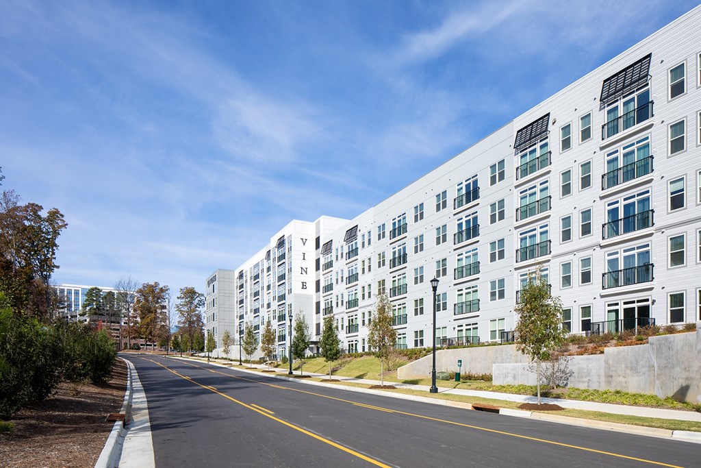 a large white building with a street in front of it