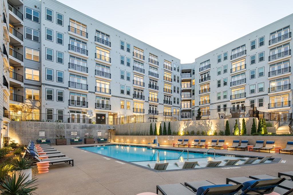a swimming pool in front of an apartment building