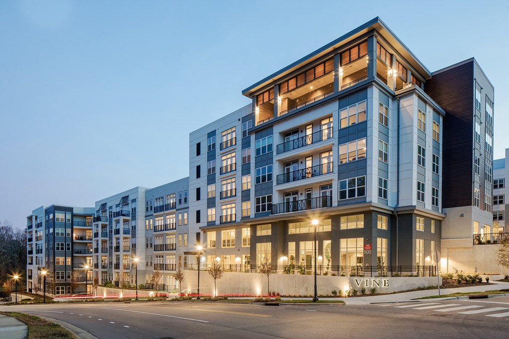 an exterior view of an apartment building at dusk