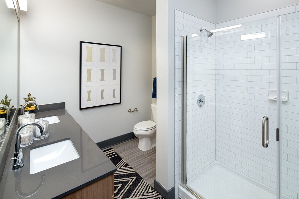 a bathroom with a shower and a sink and a mirror