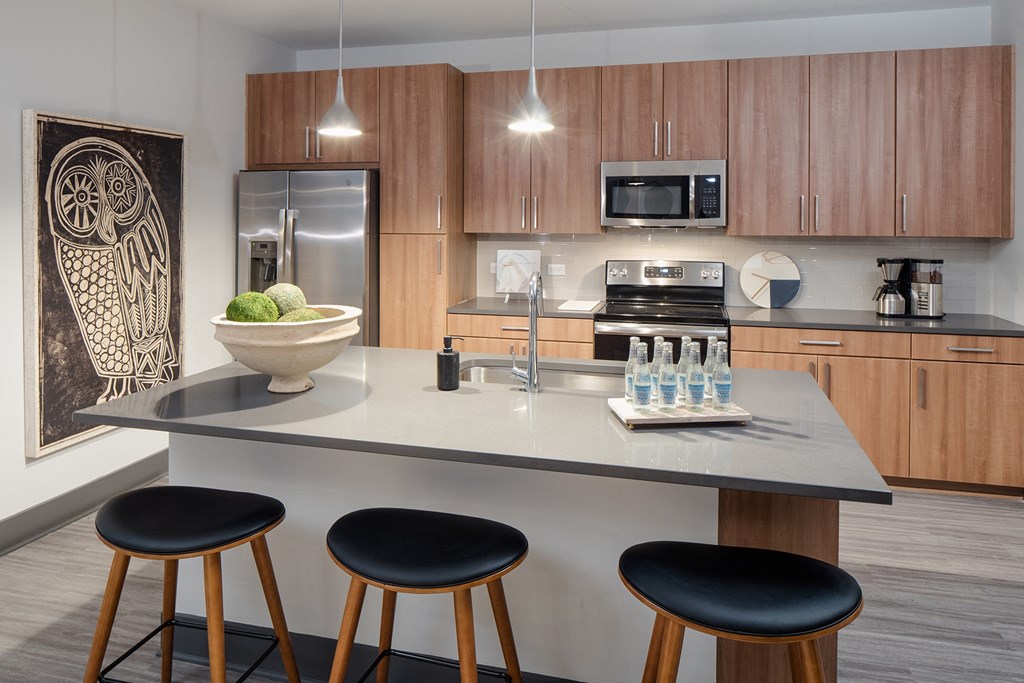 a kitchen with a center island with three stools