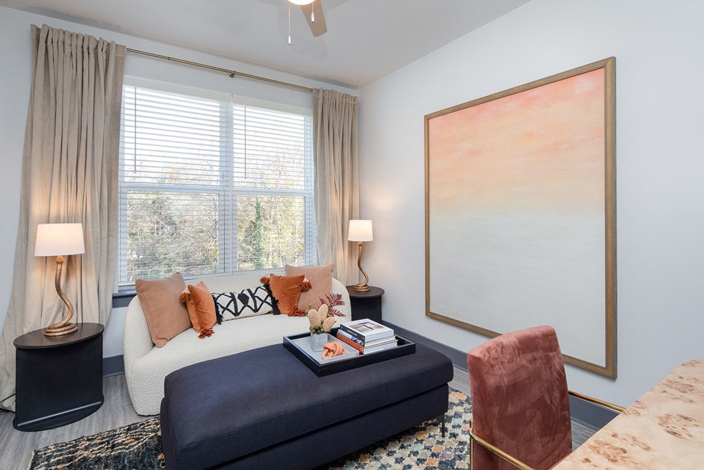 a living room with a couch and a large painting on the wall