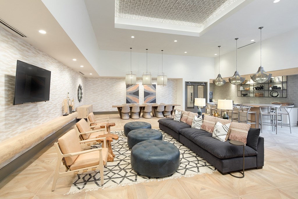 a living room with a couch and chairs and a television