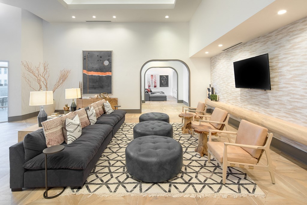 a living room with a couch and chairs and a television