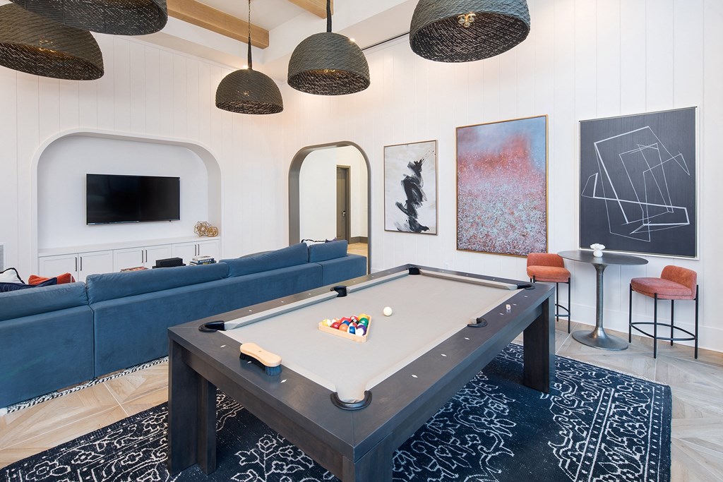 a living room with a pool table and a television