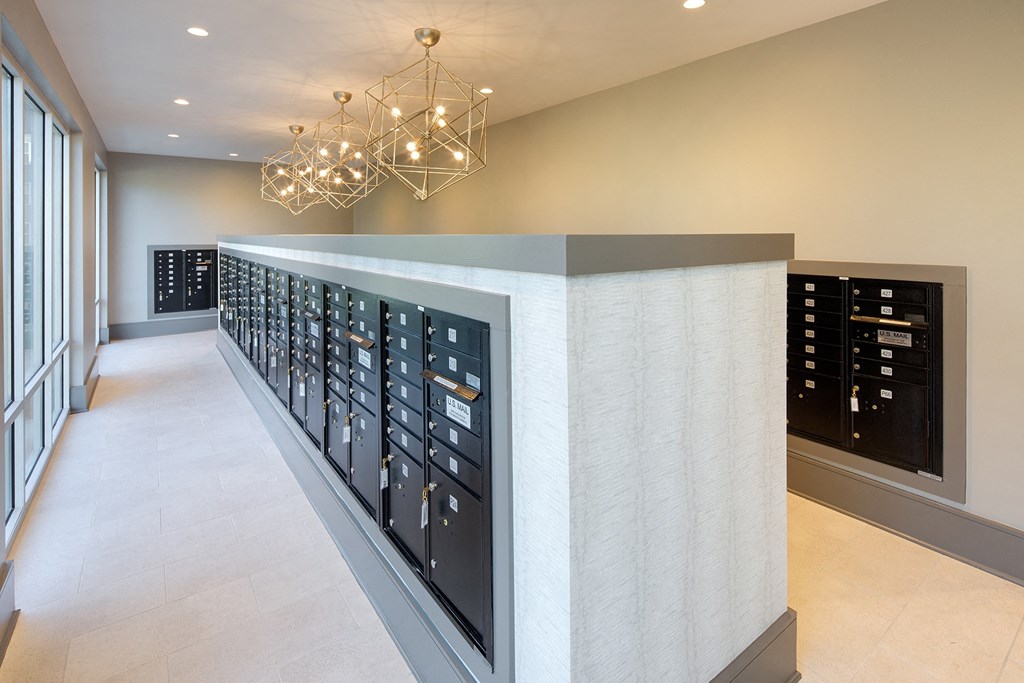 the tasting room has a wall of wine racks and a chandelier