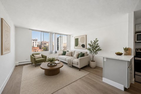 A living room with a brown coffee table and white couches.