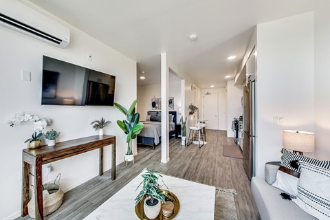 A living room with a white couch and a wooden table.