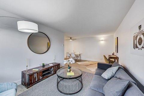 A living room with a grey couch and a coffee table.