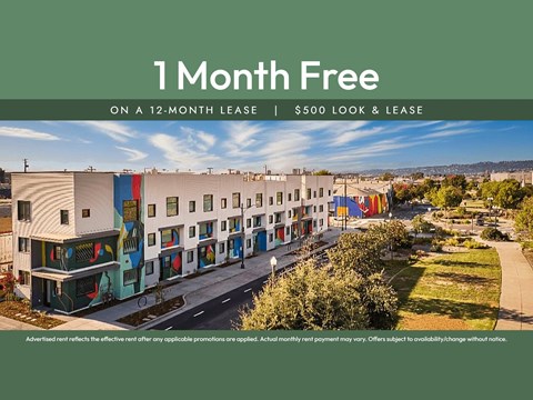 A building complex with a sign offering a free month on a 12-month lease.
