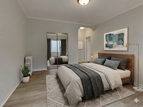 A bedroom with a large bed and a painting on the wall.