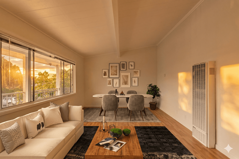 A living room with a white couch, a coffee table, and a dining table set up.