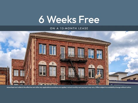 A building with a sign that says "6 Weeks Free on a 13-month lease".