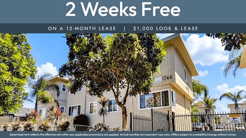 A house with a sign offering 2 weeks free on a 12-month lease.