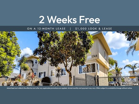 A house with a sign offering 2 weeks free on a 12-month lease.
