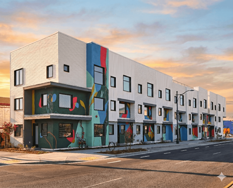 A modern building with a white facade and colorful accents.