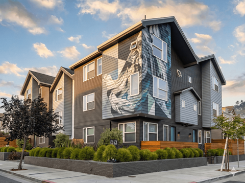 A modern house with a large mural on the side.