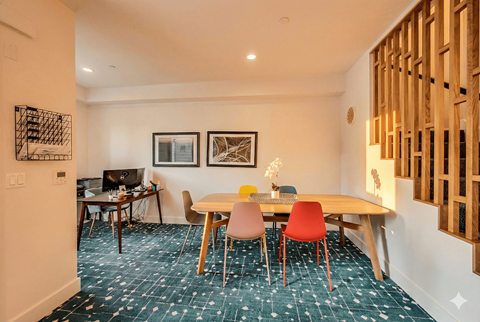 A room with a table and chairs in it.
