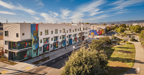 A street view of a row of colorful buildings.