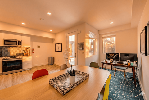 A modern kitchen with a dining table and chairs.