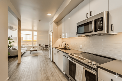 A modern kitchen with a stainless steel oven and microwave.
