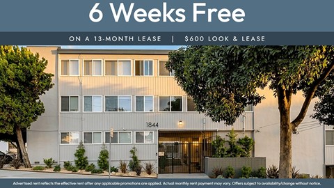 A building with a sign offering 6 weeks free on a 13-month lease for $600.