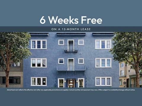 A blue apartment building with a sign offering 6 weeks free on a 13-month lease.