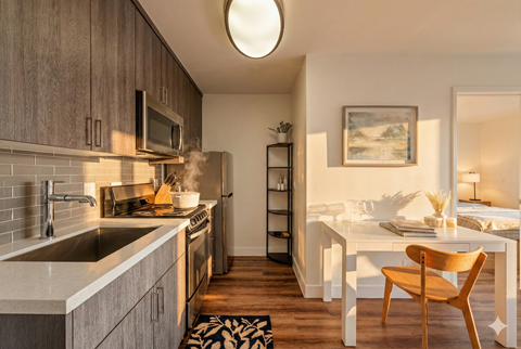 A kitchen with a wooden chair and a white table.