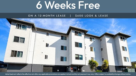A modern apartment building advertises a 6 weeks free offer on a 12-month lease.