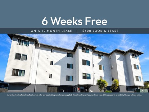 A modern apartment building advertises a 6 weeks free offer on a 12-month lease.
