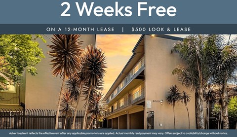 A building with a sign that says "2 Weeks Free on a 12-month lease | $500 look & lease".