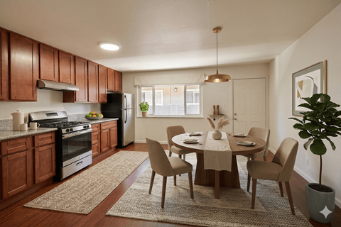 A kitchen with brown cabinets and a dining table with chairs.