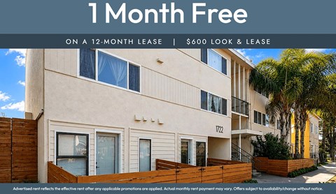 Apartment building with a sign offering a free month on a 12-month lease.