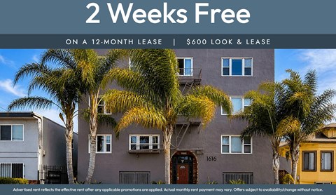 A building with a sign that says "2 Weeks Free on a 12-month lease | $600 look & lease".