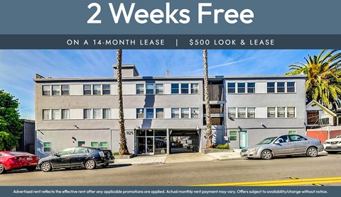 A building with a sign offering a 2 weeks free on a 14-month lease.