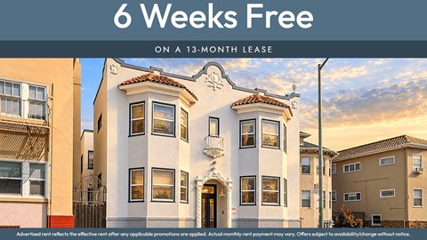 A building with a sign that says "6 Weeks Free on a 13-month lease".