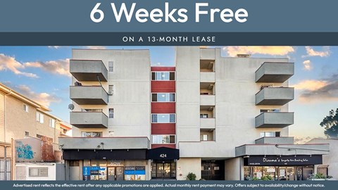 A building with a sign that says "6 Weeks Free on a 13-month lease".