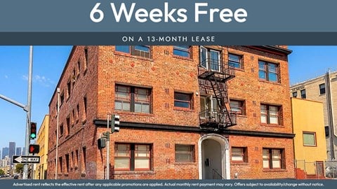 A red brick building with a sign that says "6 Weeks Free on a 13-month lease".