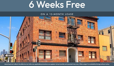 A red brick building with a sign that says 6 Weeks Free on a 13-month lease.