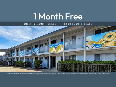 A building with a mural of a bird on it is advertising a free month on a 12-month lease.