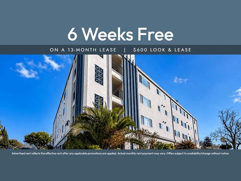 A building with a sign offering a 6 weeks free on a 13-month lease.