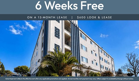 A building with a sign offering a 6 weeks free on a 13-month lease.