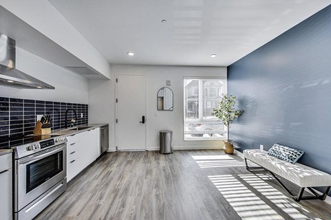 A modern kitchen with a white stove top oven and a white fridge.