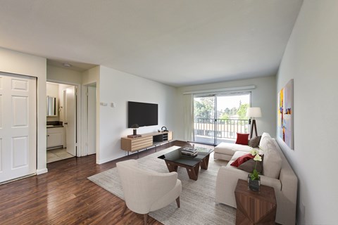 A living room with a white couch and a television.