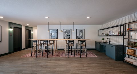 A modern kitchen with a dining table and chairs.