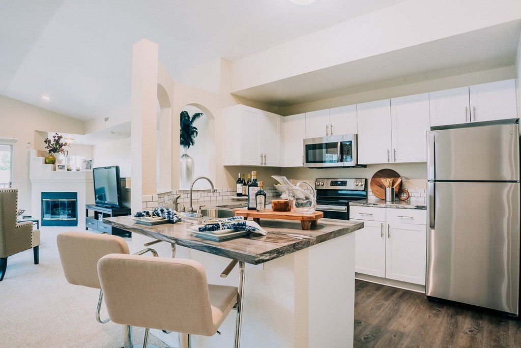 Dining area and kitchen with stainless steel appliances
